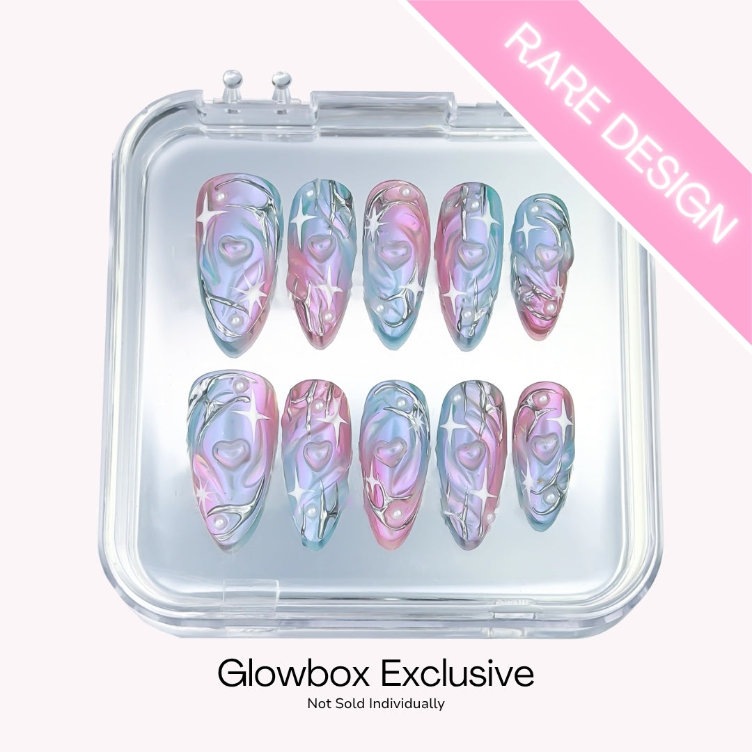 Lunoxcore Cosmic Crush press-on nails — rare Glowbox-exclusive design featuring pastel marble swirls of blue, pink, and violet from the Loudcore collection.