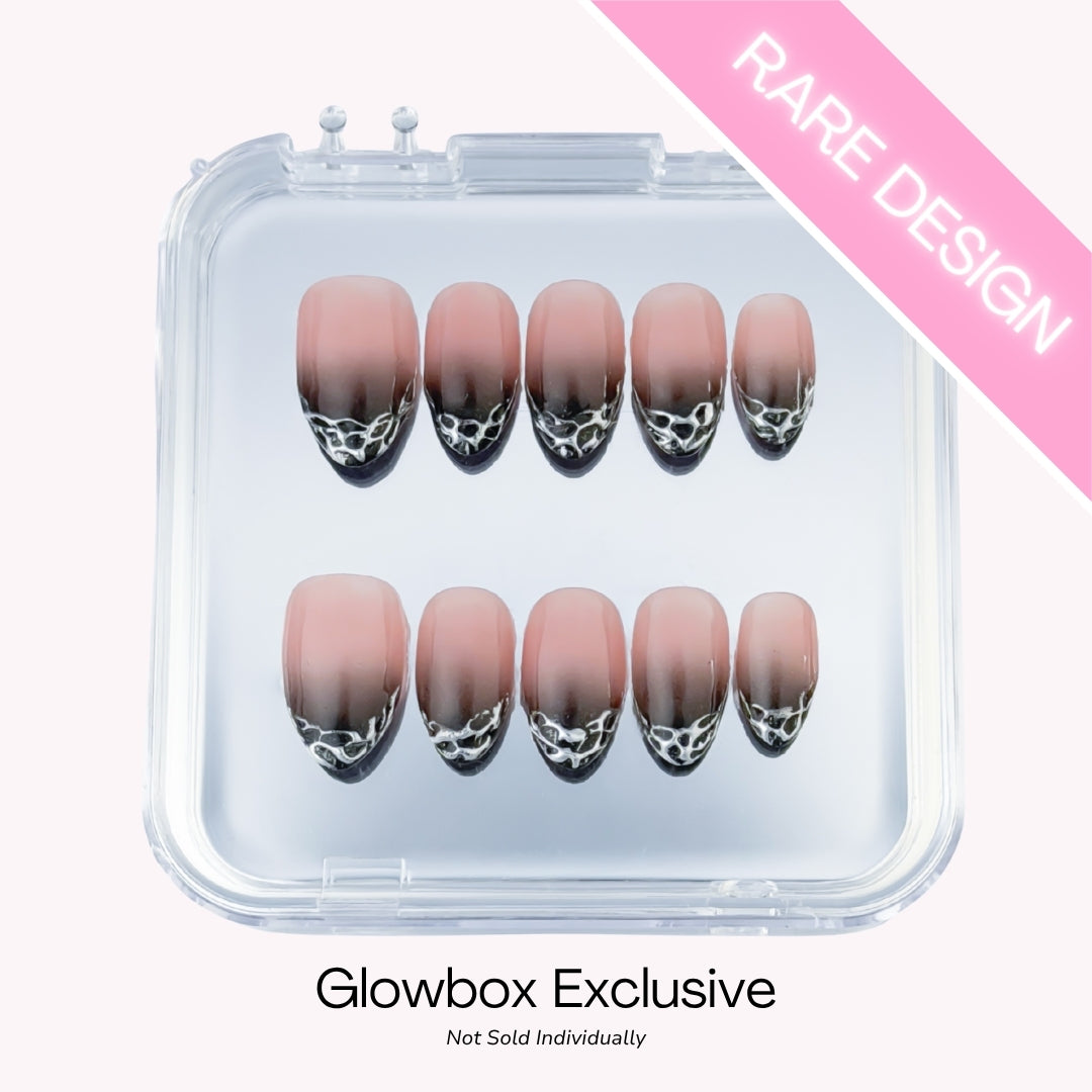 Lunoxcore Liquify press-on nails — rare Glowbox-exclusive design featuring smoky ombré nude base with molten chrome drips, not sold individually