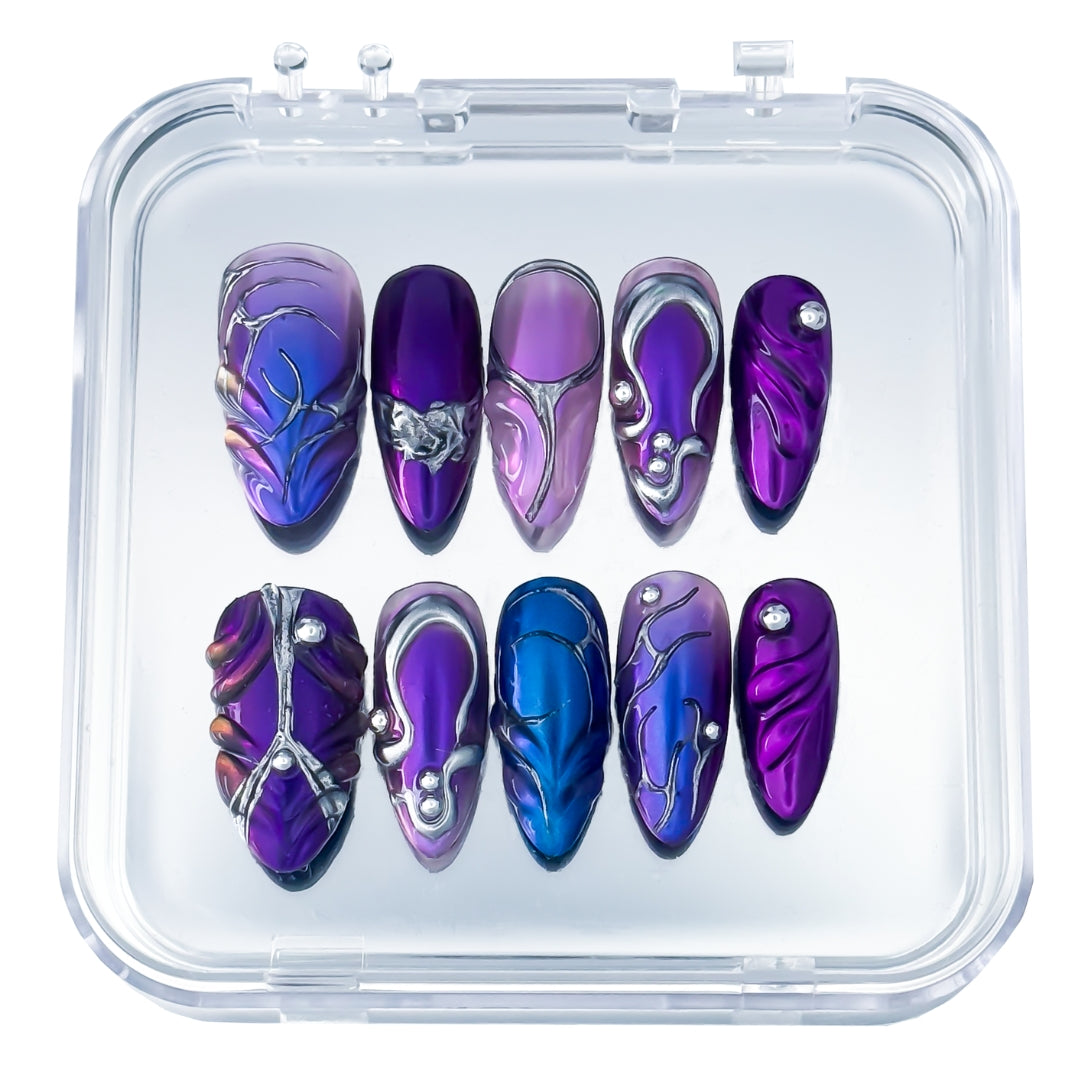 Lunoxcore Ultraviolet press-on nails — deep purple and electric blue design with metallic chrome accents from the Loudcore Glowbox collection