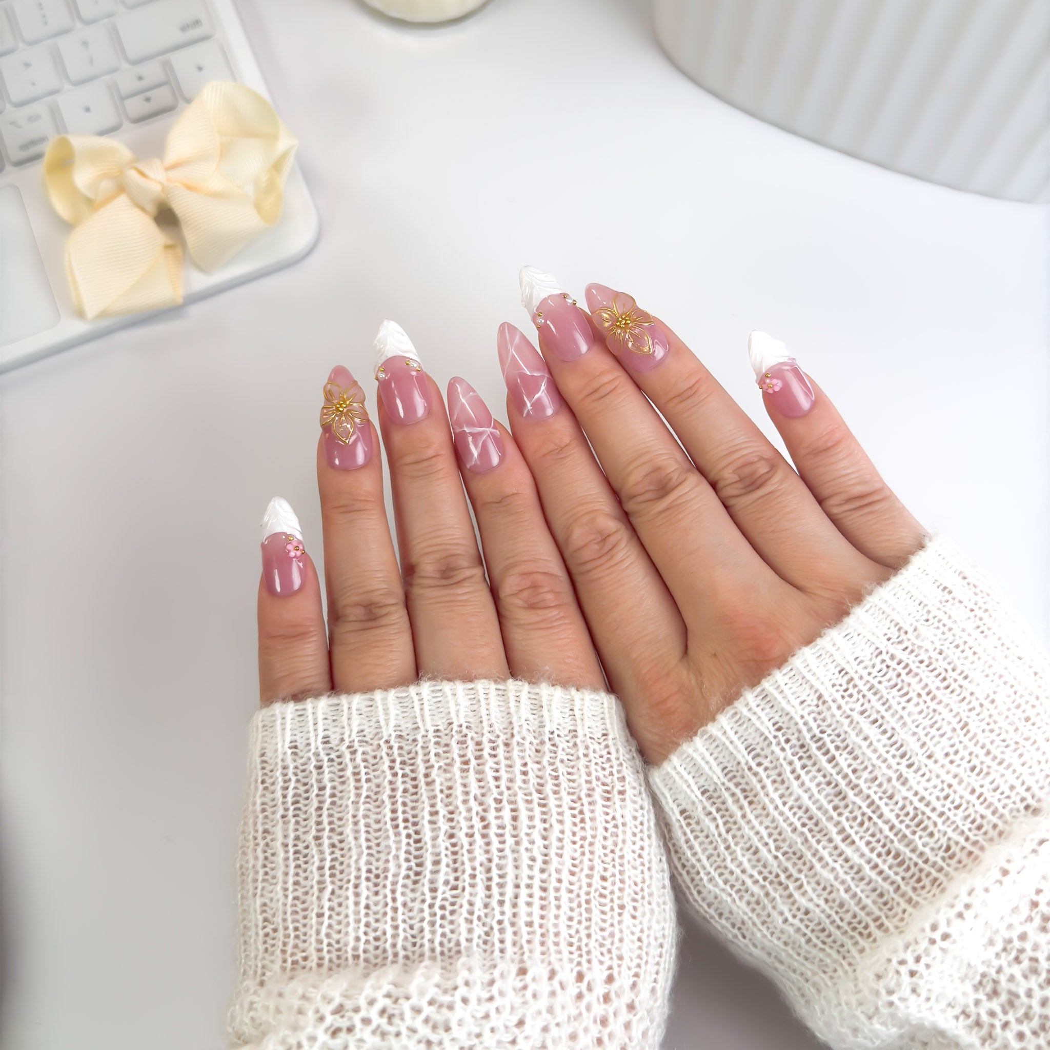Top-down view of Blossoming press-on nails — a refined blend of pink warmth, silver elegance, and blooming gold details symbolizing beauty in full bloom.