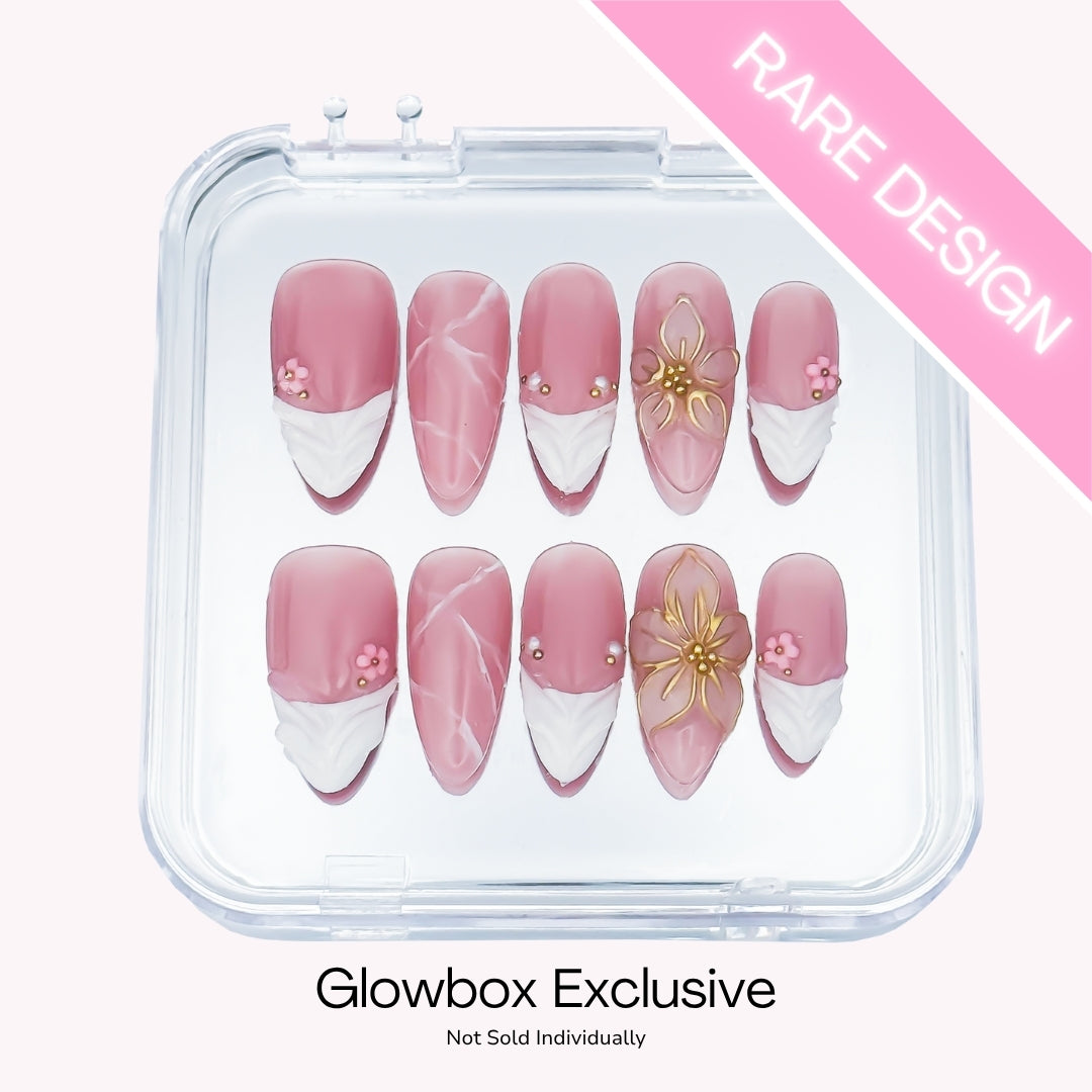 Lunoxcore Blossoming press-on nails — rare Glowbox-exclusive design featuring pink ombré nails with hand-placed gold floral accents from the Evening Glow collection.