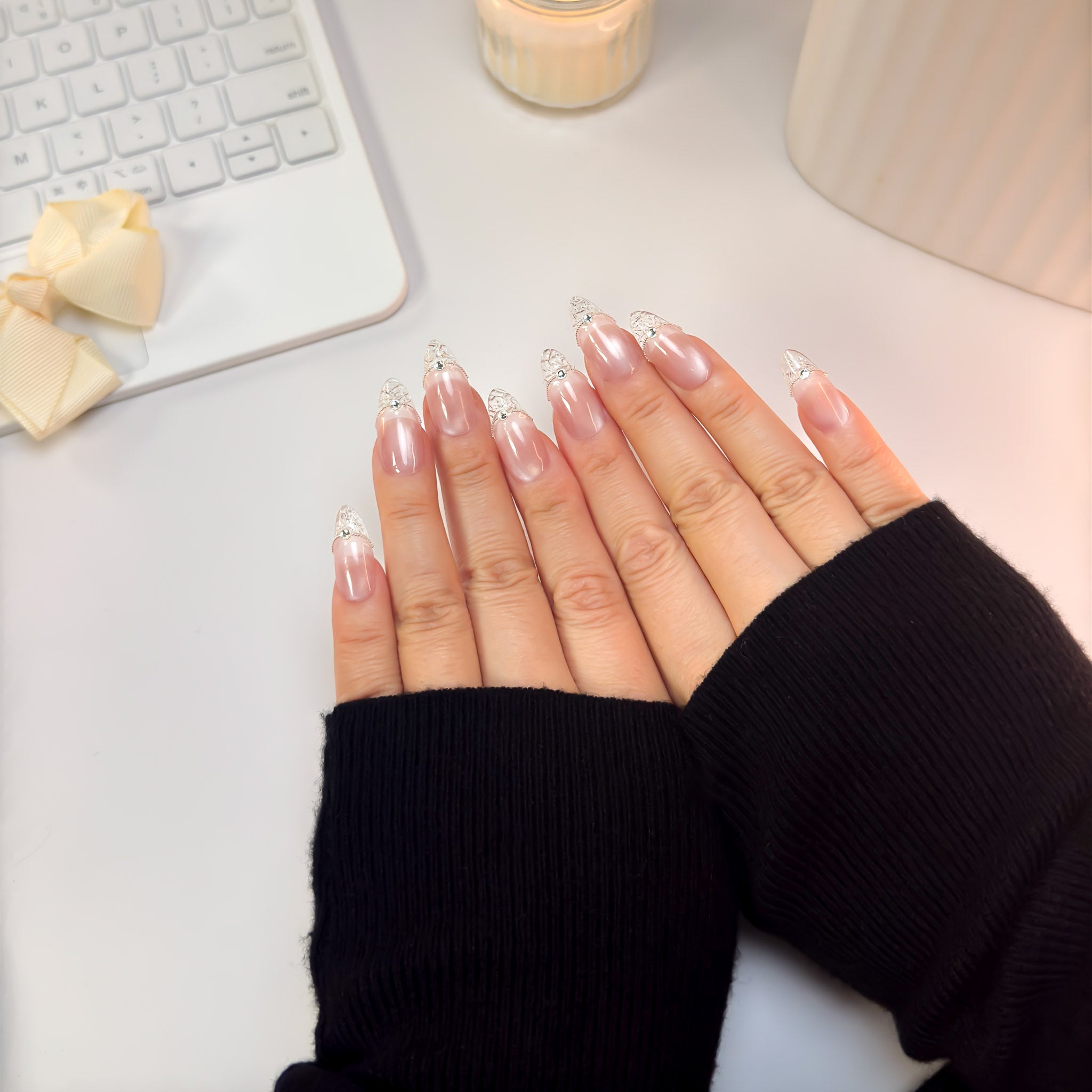 Top-down view of Crystal Cut nails — featuring a clean blush base and faceted clear tips that catch the light beautifully.