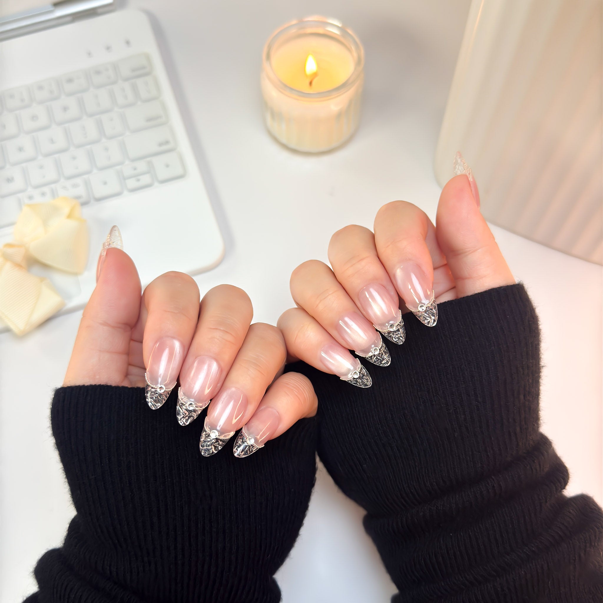 Crystal Cut nails shown from a side angle — a perfect blend of soft nude blush and sculpted transparent crystal tips.