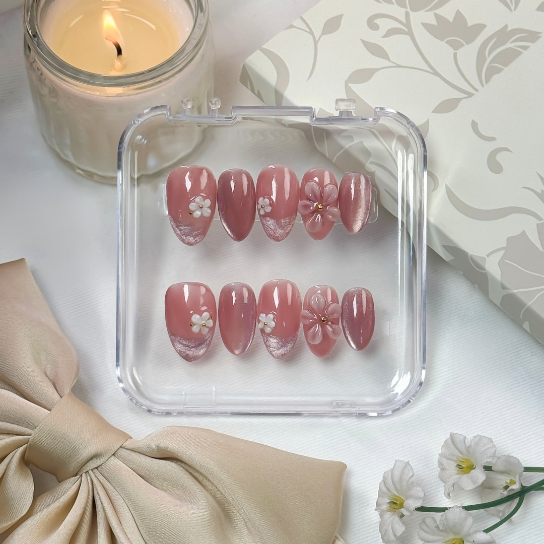 Lunoxcore Daisy Daze press-on nails — soft pink ombré design with 3D white flower charms and gold centers from the Whispered Shine Glowbox collection.