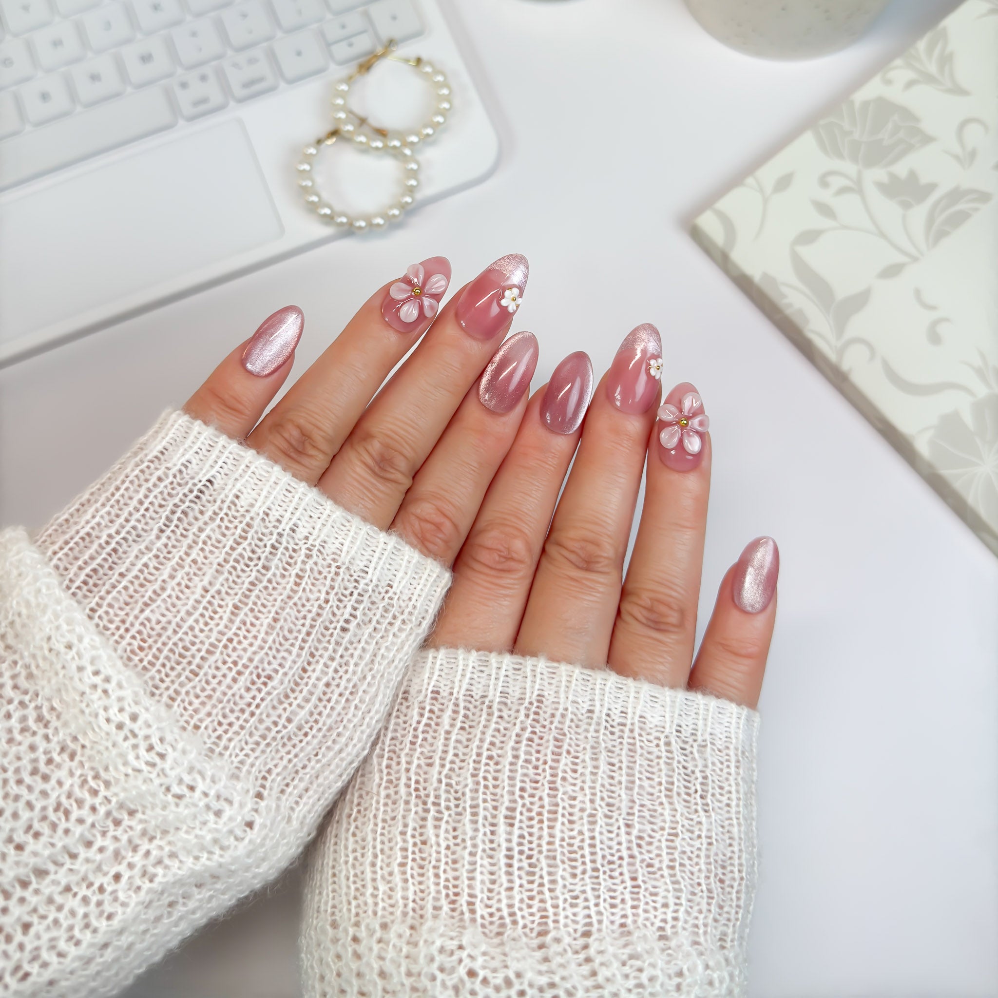 Full view of Daisy Daze nails — glossy blush tones with layered flower details and pearl centers, blending playful charm with elegance.
