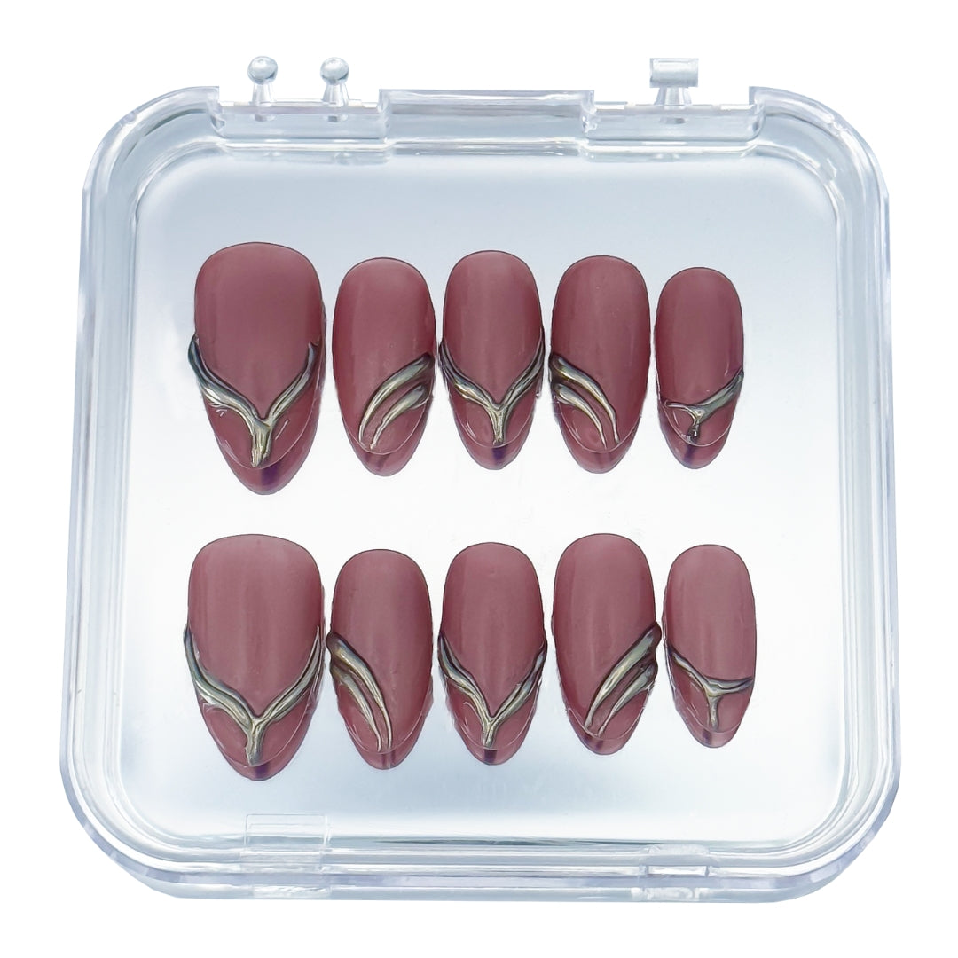 Gilded Strike press-on nails by Lunoxcore — deep mauve tones enhanced with molten gold chrome accents for a bold yet refined metallic statement.