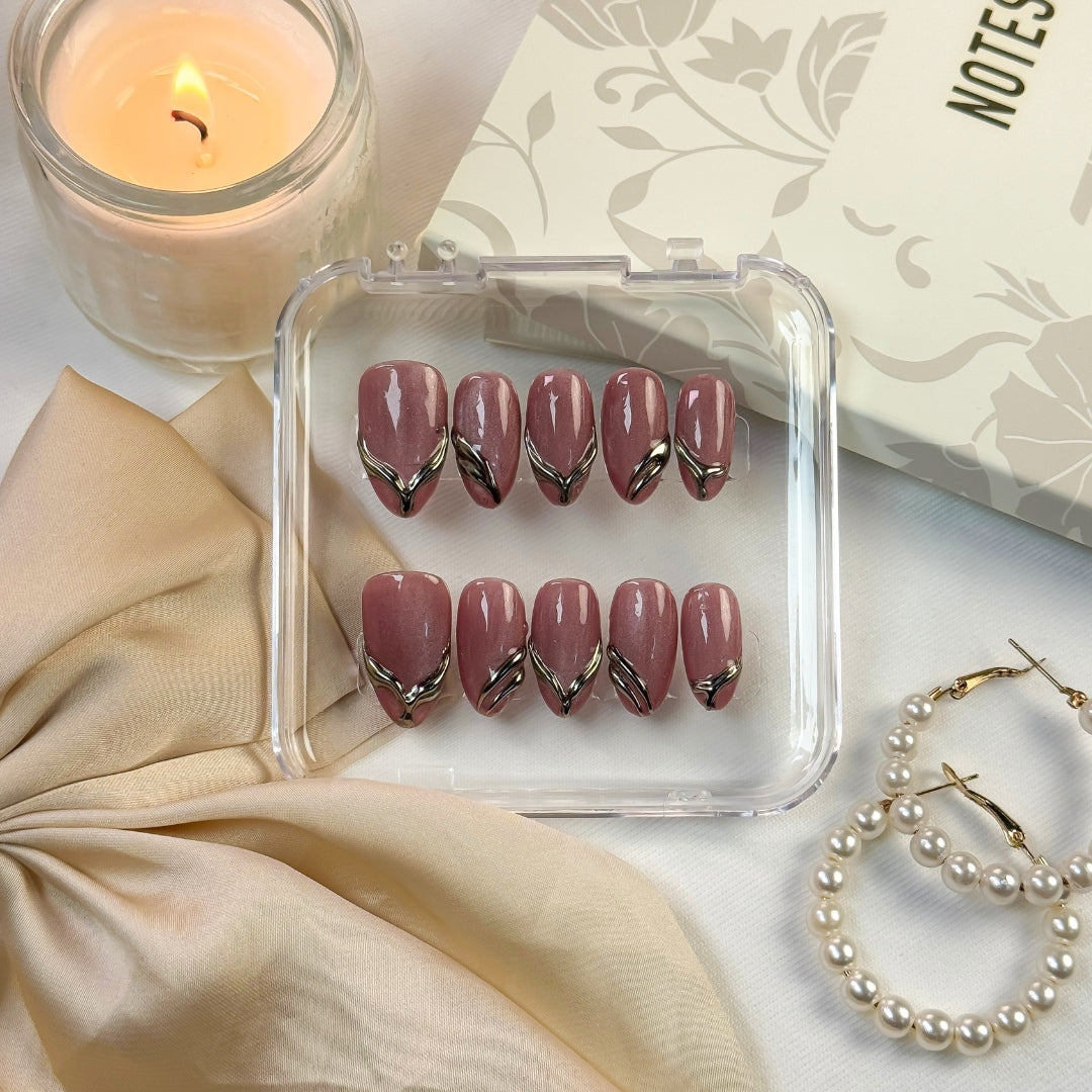 Gilded Strike press-on nails by Lunoxcore — deep mauve tones enhanced with molten gold chrome accents for a bold yet refined metallic statement.