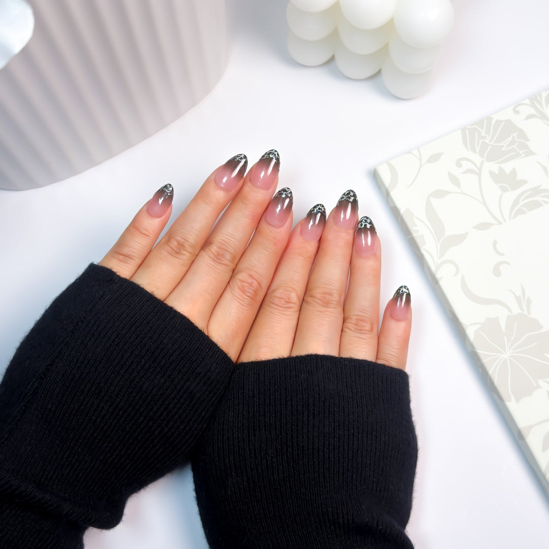 Top-down view of Liquify nails — unique smoky ombré fade with silver chrome drips, a signature rare design from Lunoxcore’s Glowbox collection.