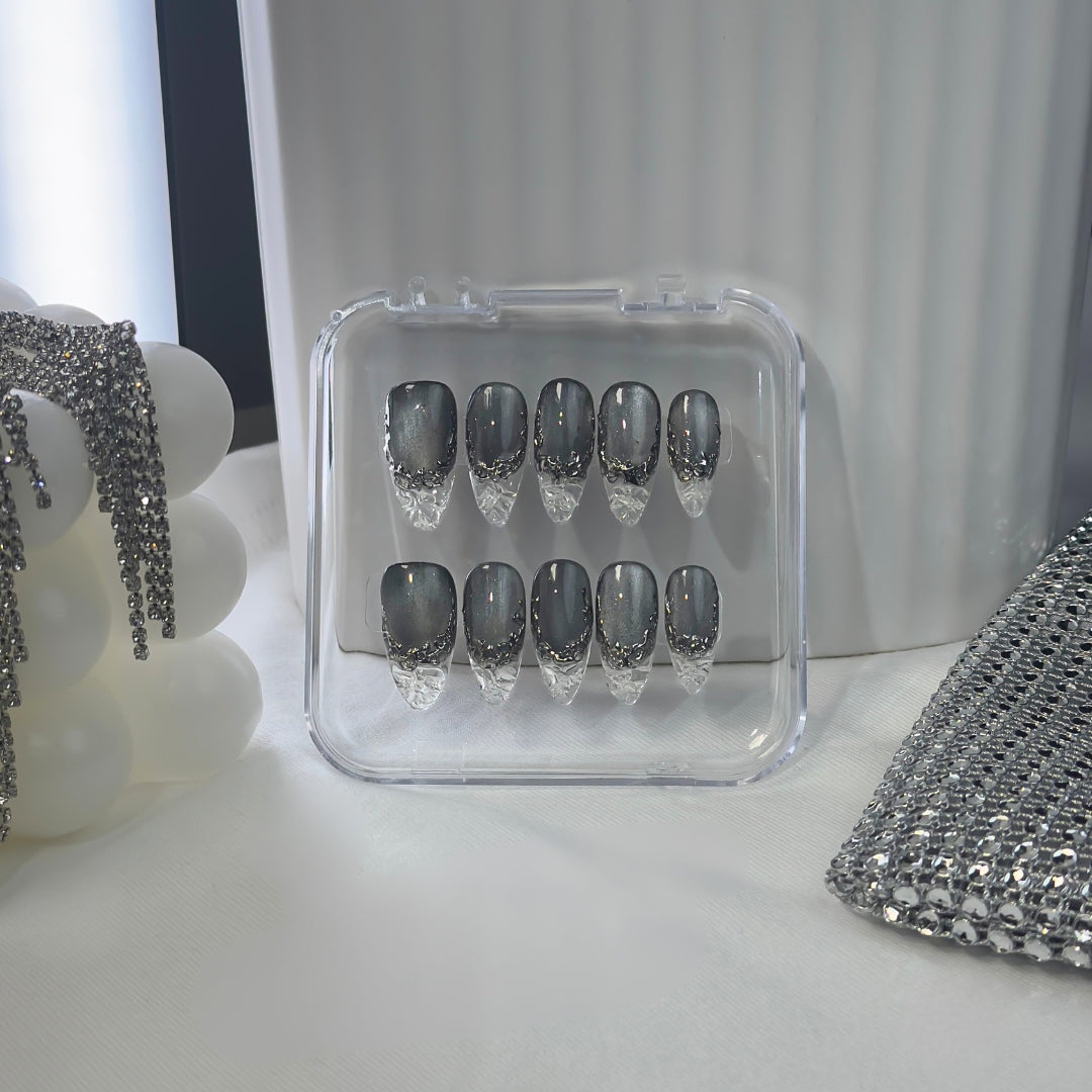 Lunoxcore Molten Glass press-on nails — matte black and silver chrome design inspired by molten metal from the Loudcore Glowbox collection.