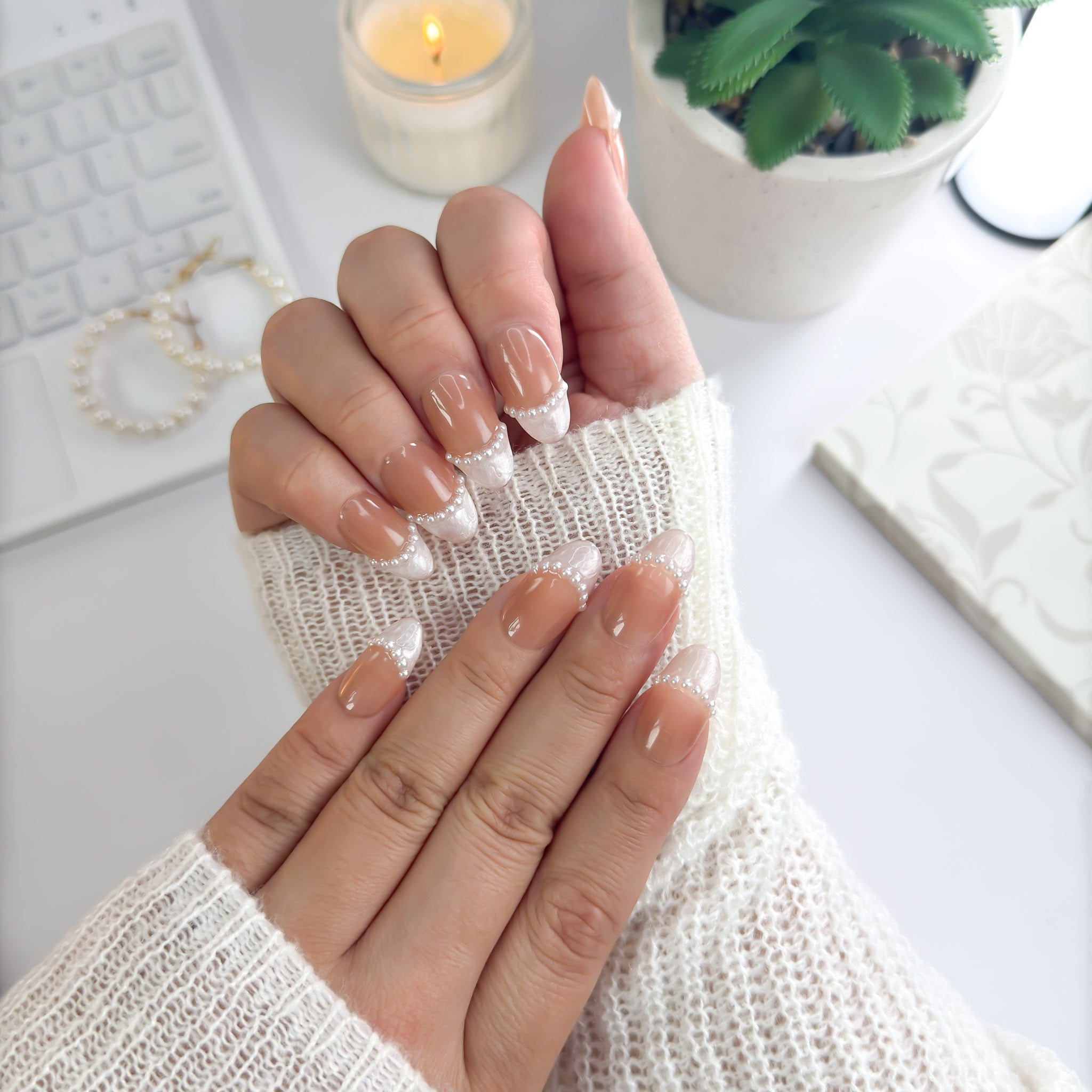 Pearl Veil nails worn under candlelight — nude base paired with pearly white tips, perfect for soft, graceful looks.