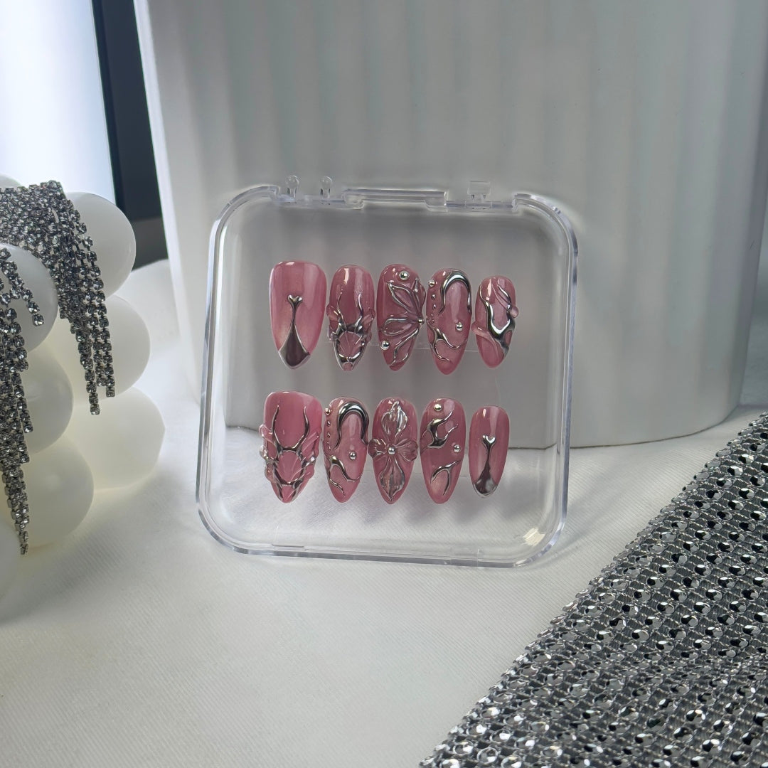 Lunoxcore Pink Dimension press-on nails — bright pink and white chrome swirl design with sculptural accents from the Loudcore Glowbox collection