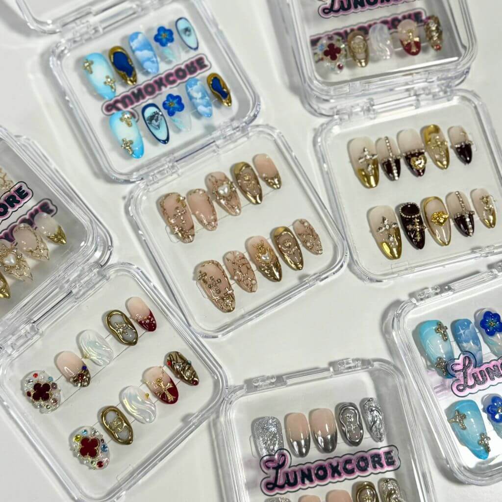 Lunoxcore press-on nail bundles featuring assorted handcrafted designs — from gold accents to pastel hues — perfect for mix-and-match styles or gifting.