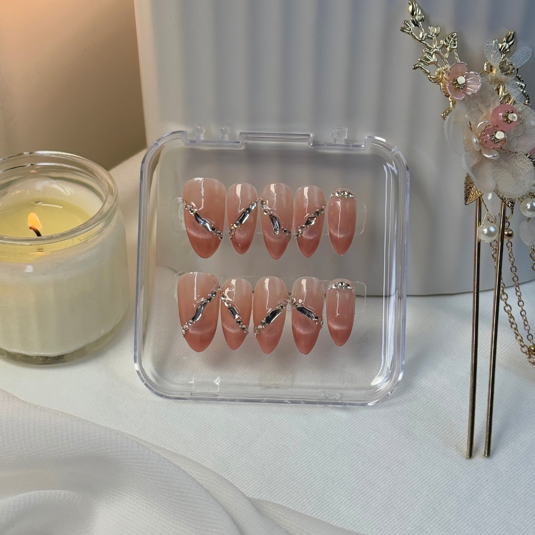 Lunoxcore Sunlit press-on nails — warm peachy pink design with crystal accents and radiant shine from the Evening Glow Glowbox collection.