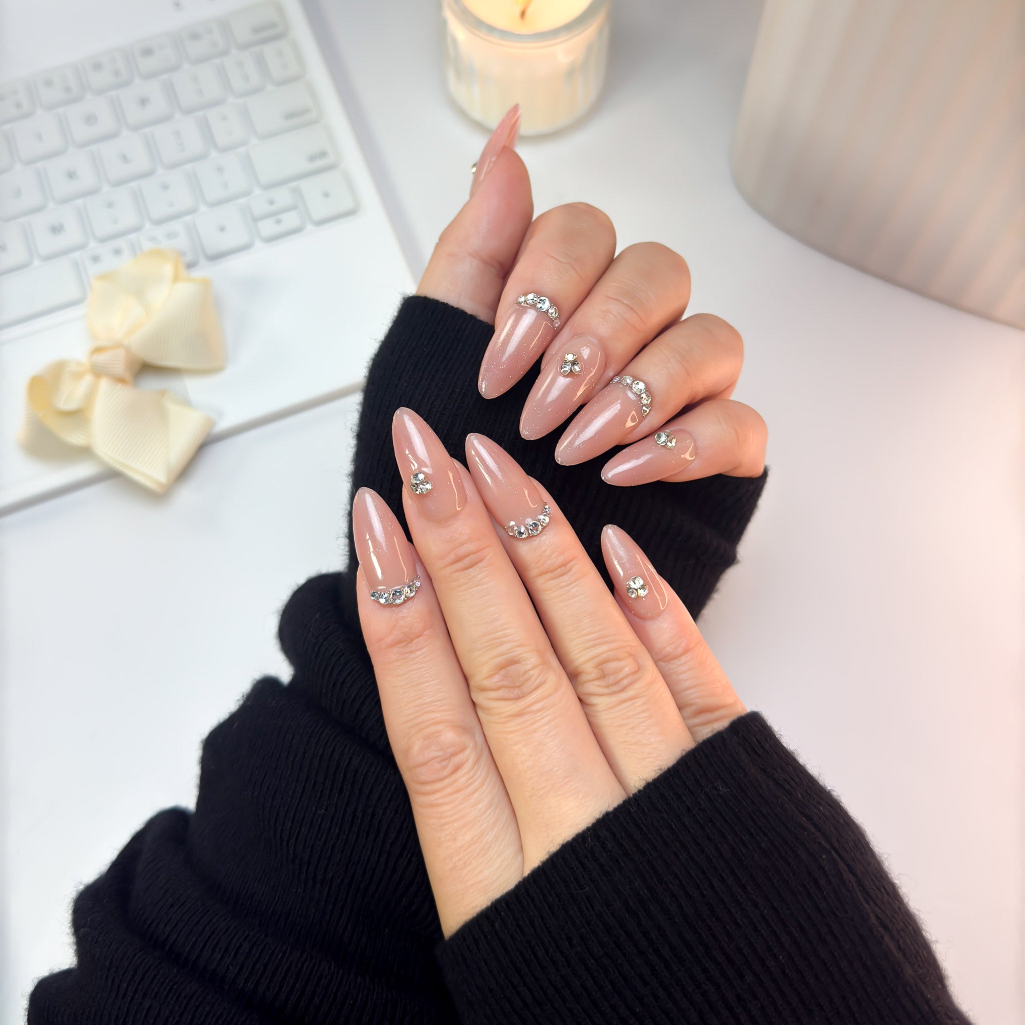 Twinkle Touch press-on nails worn in a front pose — a graceful balance of nude-pink tones and crystal shine that exudes understated elegance.