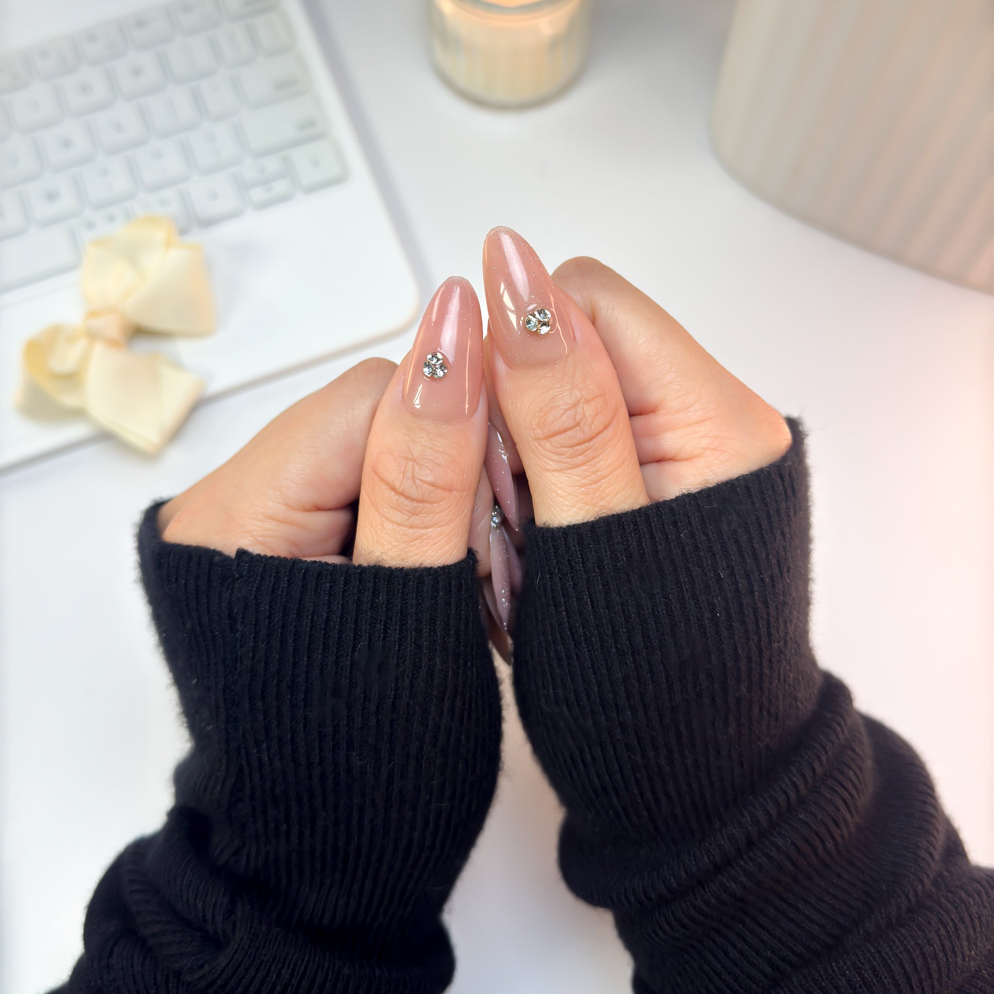 Close-up of Twinkle Touch nails highlighting the clear sparkle of the crystal accents against a nude-blush gradient base.