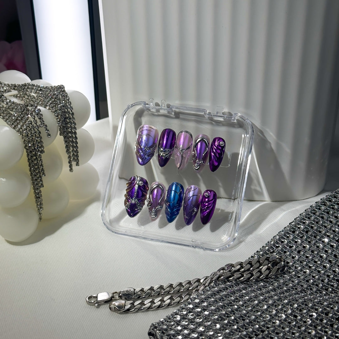 Lunoxcore Ultraviolet press-on nails — deep purple and electric blue design with metallic chrome accents from the Loudcore Glowbox collection