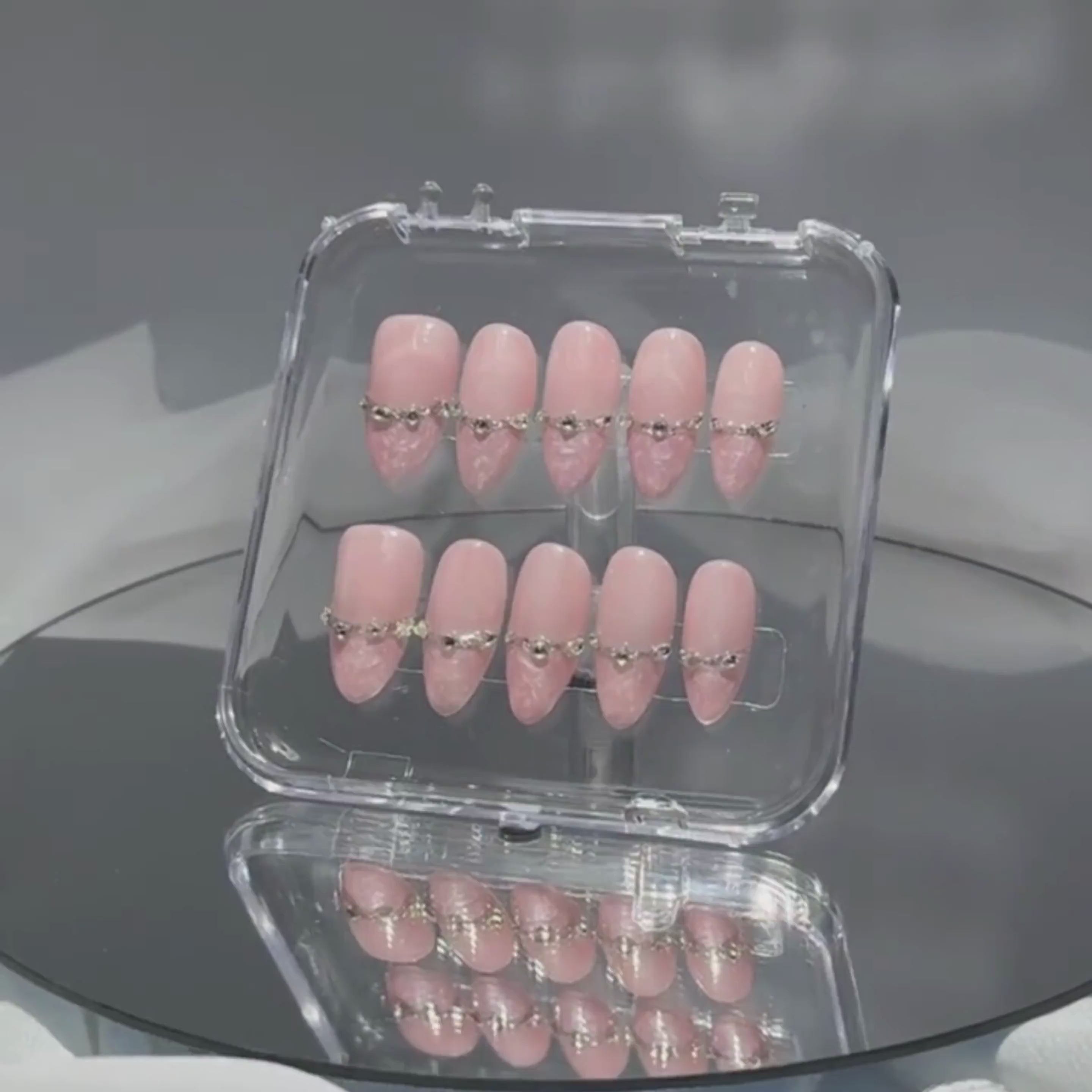 Soft-lit view of Rose Reverie press-on nails — glowing pink finish with gemstone accents, highlighting Lunoxcore’s handcrafted elegance.